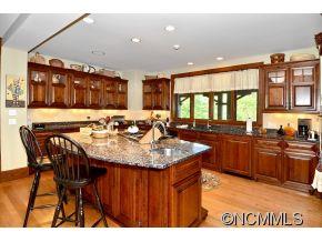 1380 Pkwy N Road Mill Spring, NC 28756 - Photo 5 of 24 a kitchen with stainless steel appliances granite countertop a sink and a white cabinets