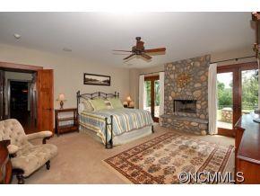 1380 Pkwy N Road Mill Spring, NC 28756 - Photo 8 of 24 a bedroom with a bed and a fireplace