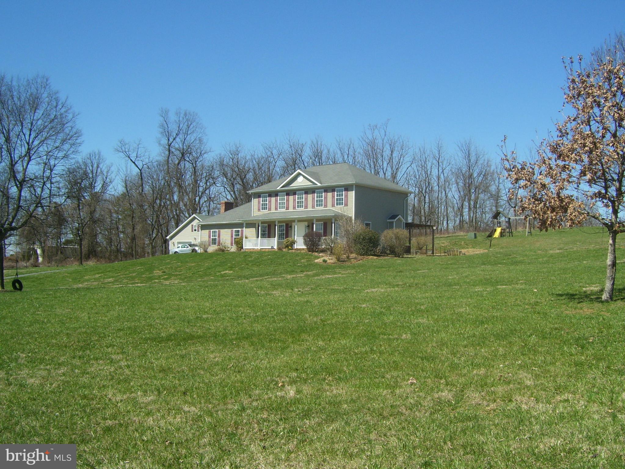 3311 Apple Pie Ridge Road Winchester, VA 22603 - Photo 3 of 23 a front view of a house with garden