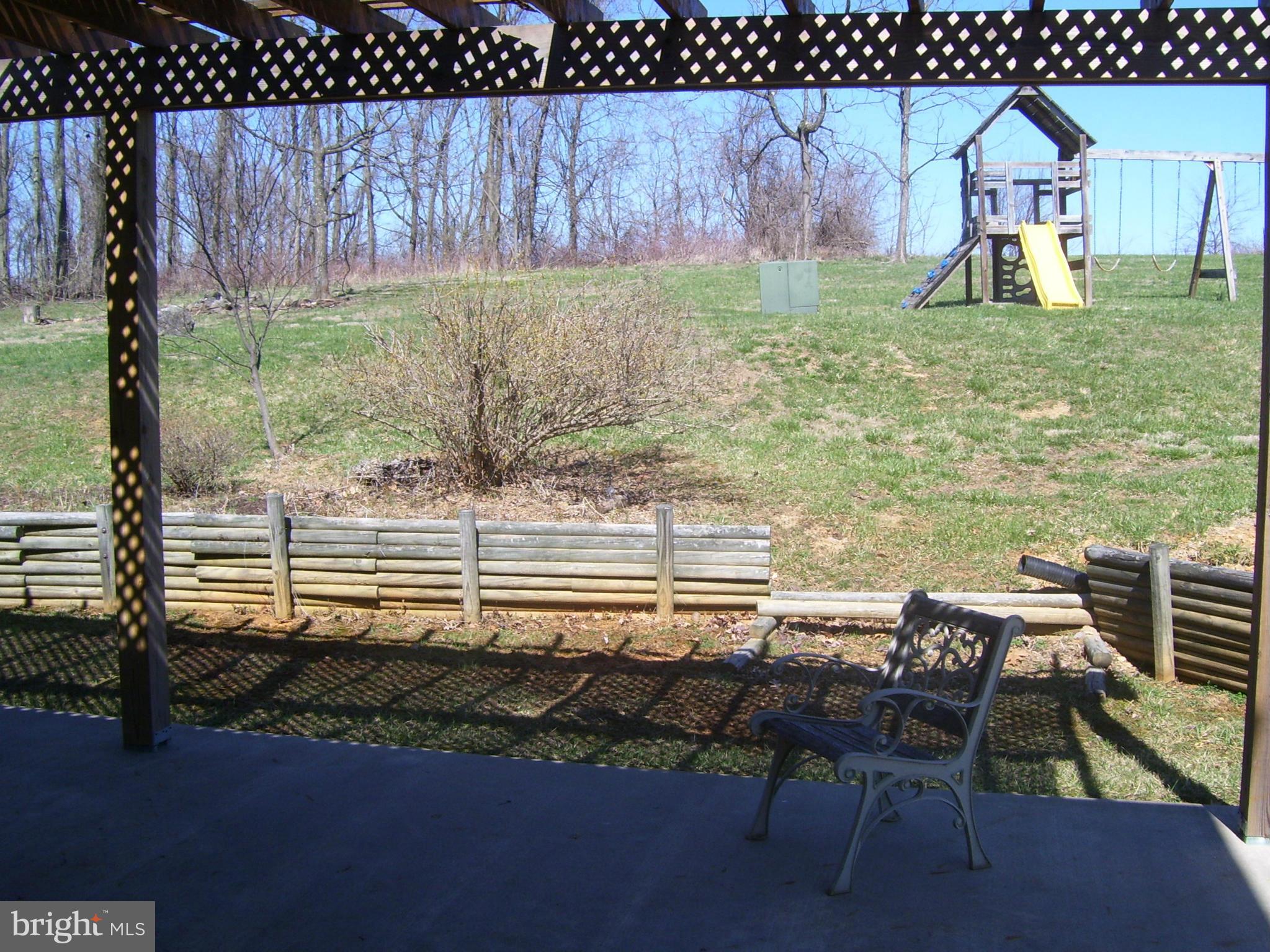 3311 Apple Pie Ridge Road Winchester, VA 22603 - Photo 7 of 23 a backyard of a house with table and chairs