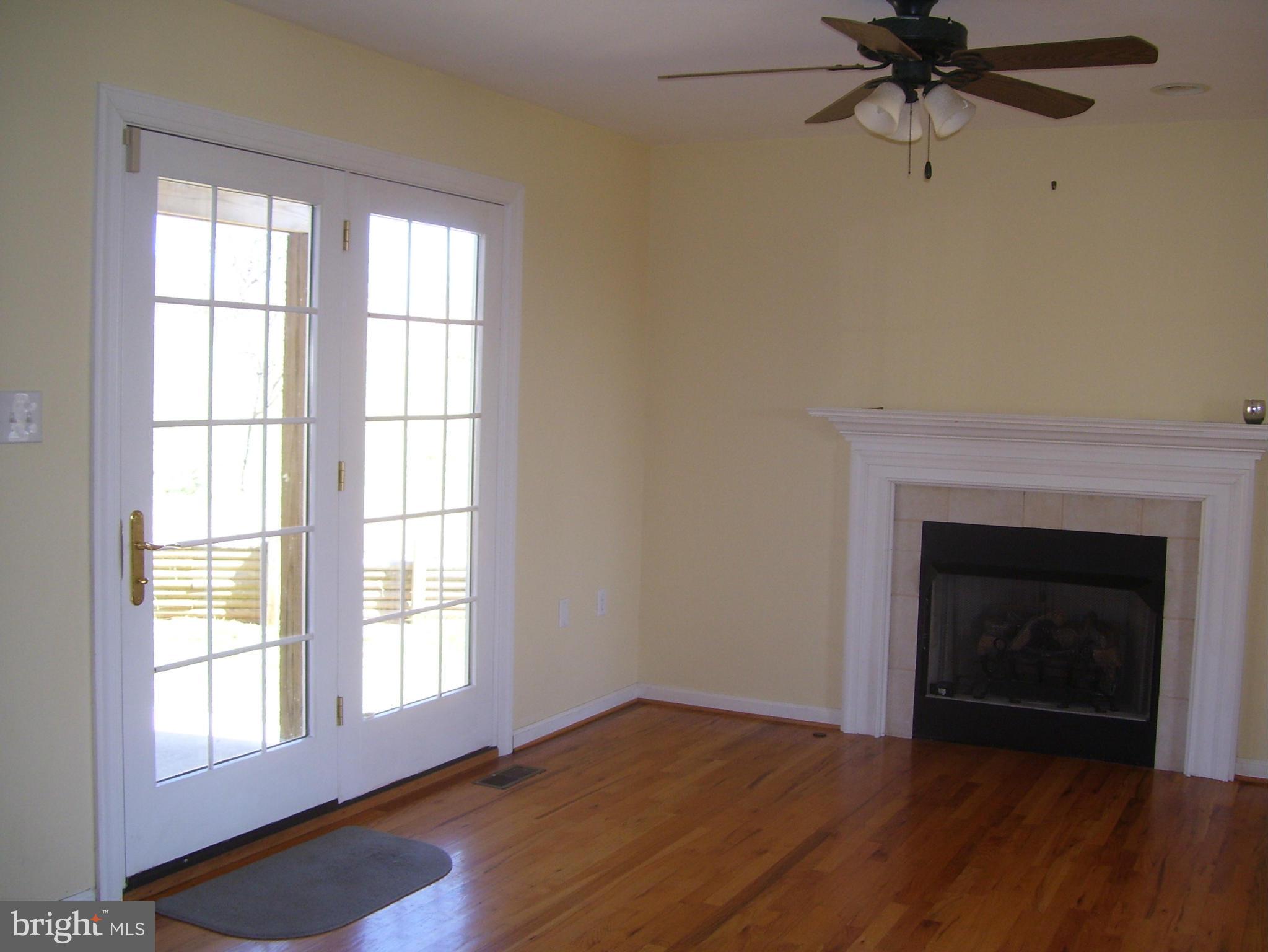 3311 Apple Pie Ridge Road Winchester, VA 22603 - Photo 8 of 23 an empty room with windows and a fireplace