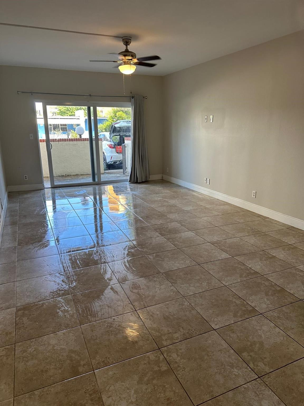 400 North Riverside Drive, Unit 102 Pompano Beach, FL 33062 - Photo 18 of 20 a view of an entryway with a floor to ceiling window and a ceiling fan