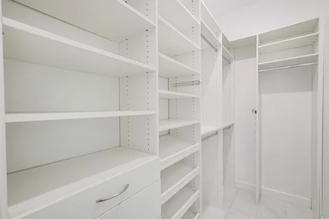 a spacious bathroom with a bathtub shower and toilet