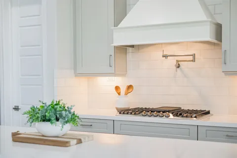 a kitchen with stainless steel appliances kitchen island granite countertop a sink and cabinets