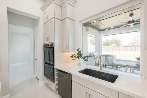 a bathroom with a potted plant and a sink