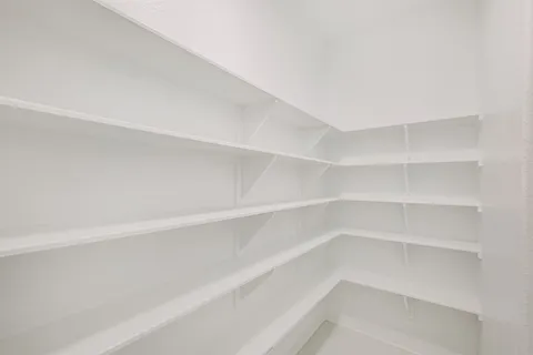 a view of a kitchen with a sink and refrigerator