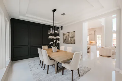 a kitchen with kitchen island a stove a table and chairs in it