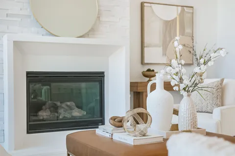 a living room with furniture a fireplace and a large window