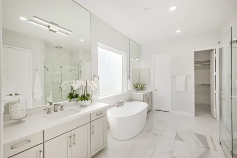 a spacious bedroom with a bed and ceiling fan