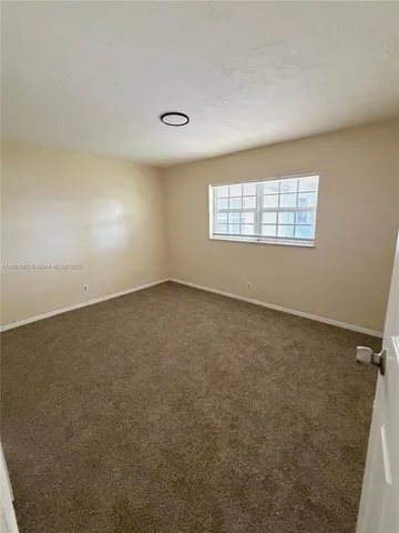 an empty room with a empty space and windows