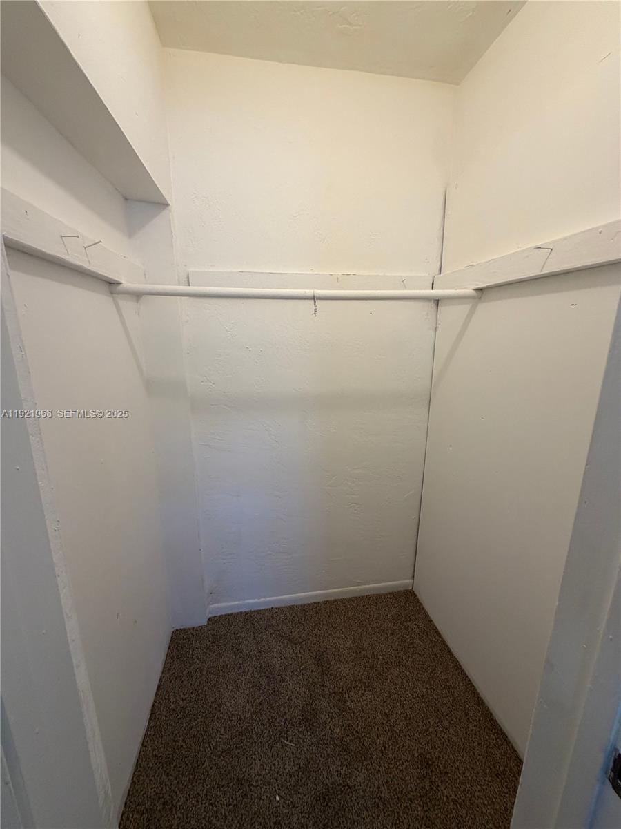 1320 Southwest 11th Avenue, Unit A Deerfield Beach, FL 33441 - Photo 7 of 9 a view of a room with racks on the wall