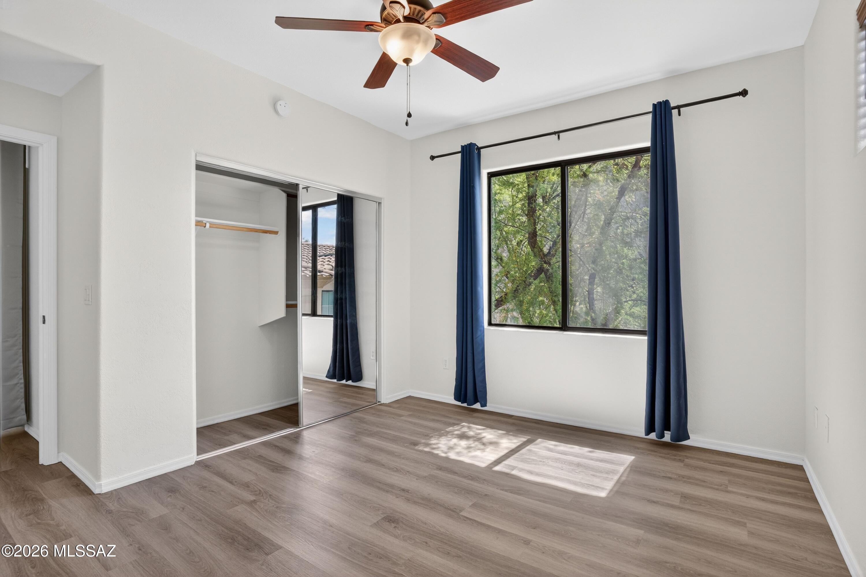 2550 East River Road, Unit 4204 Tucson, AZ 85718 - Photo 29 of 36 a view of a livingroom with wooden floor and a ceiling fan