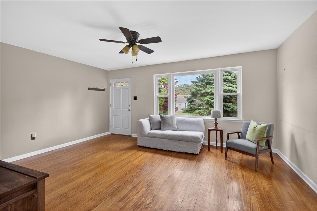 23 Harrison Street Emmaus, PA 18049 - Photo 5 of 28 Hardwood floors and ample natural light define this cozy living space, perfect for relaxation.