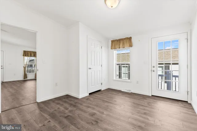 an empty room with windows and closet