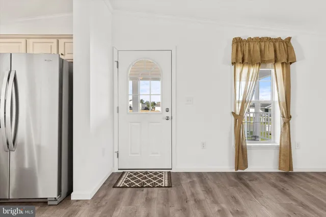 a view of a kitchen with a refrigerator and cabinet