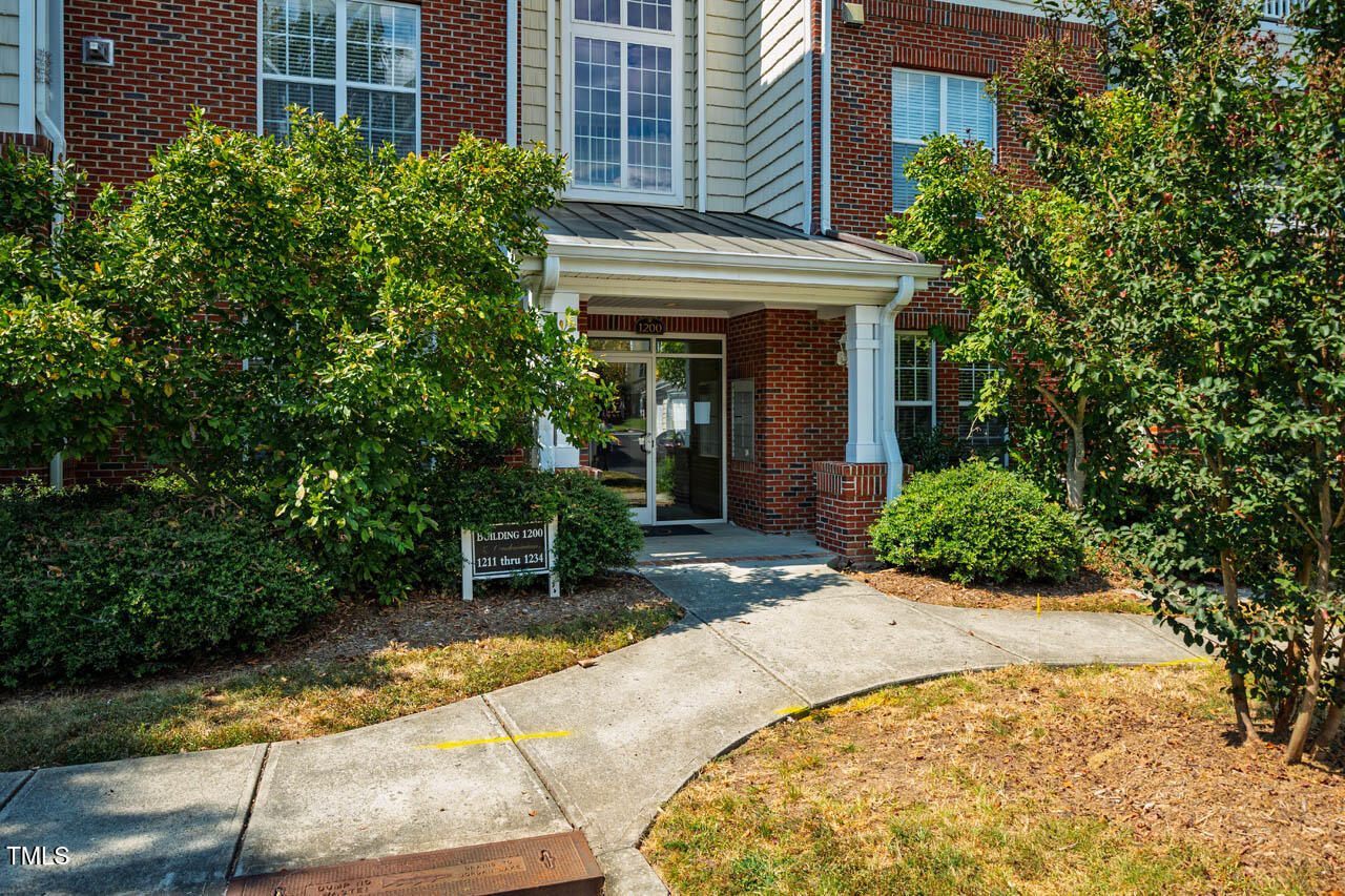 1221 Arborgate Circle, Unit 12 Chapel Hill, NC 27514 - Photo 2 of 20 a view of a patio with table and chairs and potted plants