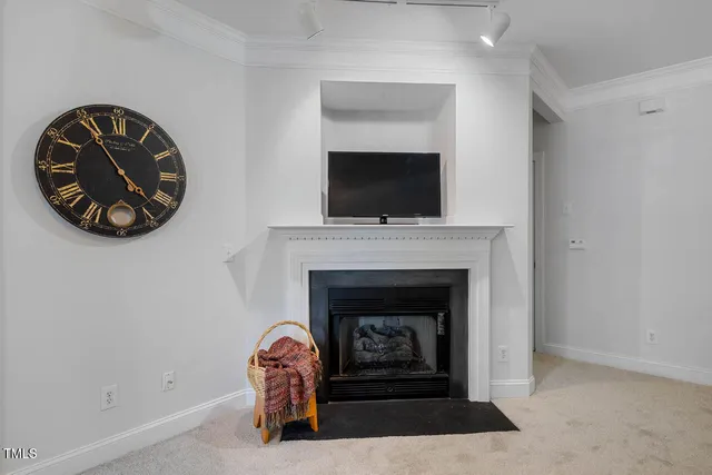 a living room with a fireplace and a flat screen tv