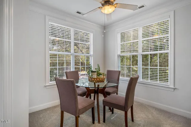 a view of a dining room with furniture and chandelier