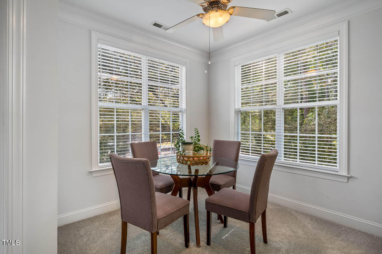 1221 Arborgate Circle, Unit 12 Chapel Hill, NC 27514 - Photo 6 of 20 a view of a dining room with furniture and chandelier