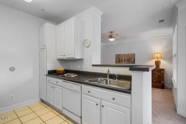 a kitchen with granite countertop white cabinets and stainless steel appliances