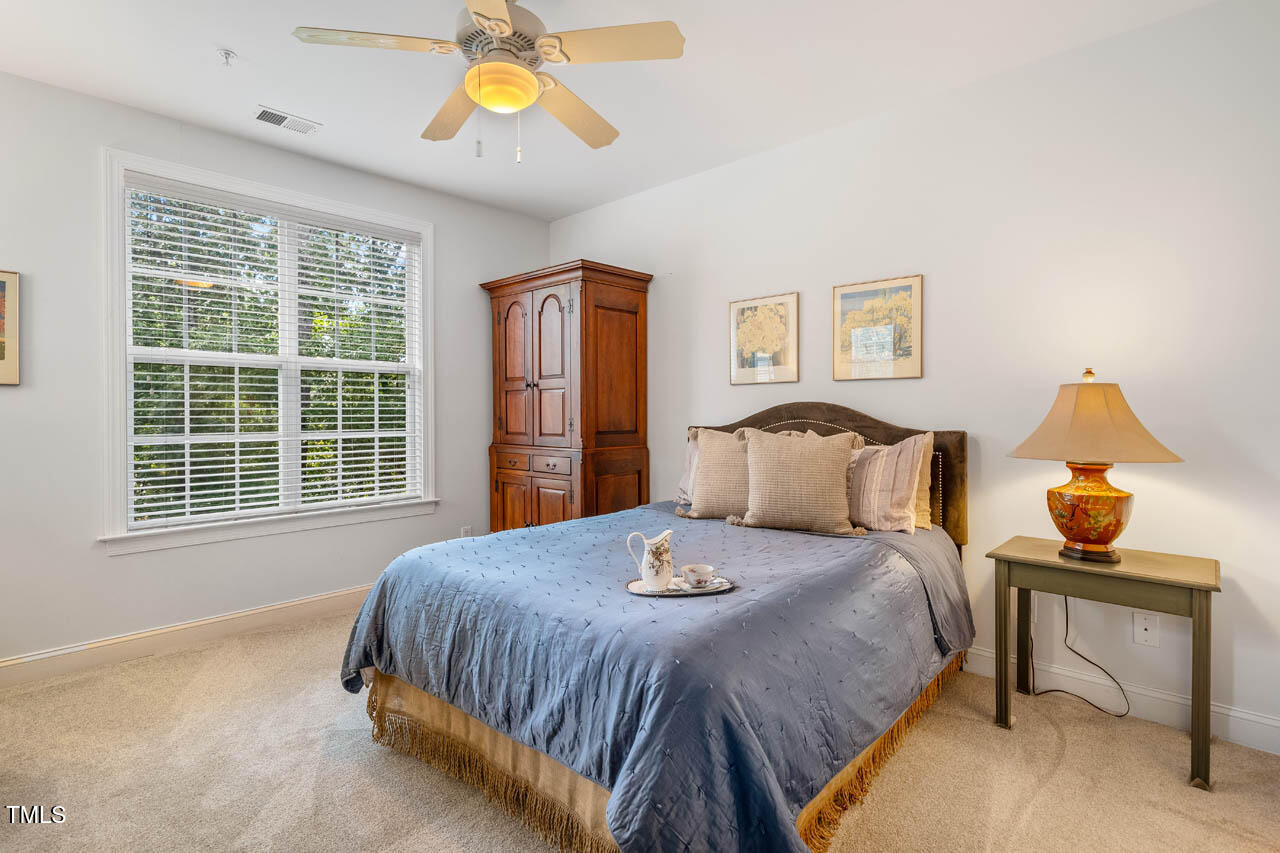 1221 Arborgate Circle, Unit 12 Chapel Hill, NC 27514 - Photo 10 of 20 a bedroom with a bed and a window