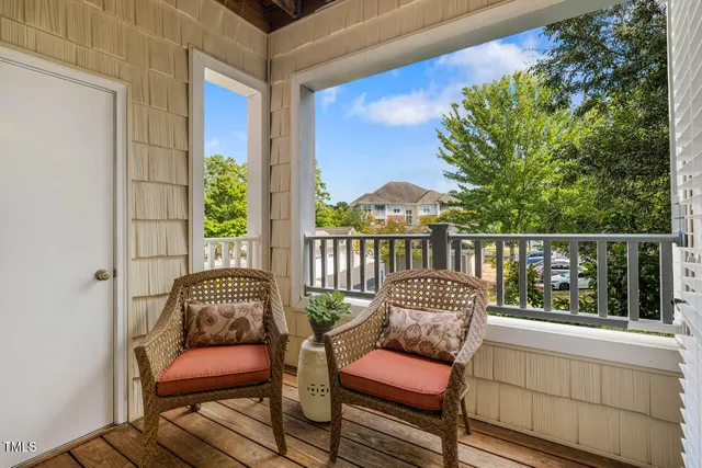 a balcony with furniture and wooden floor