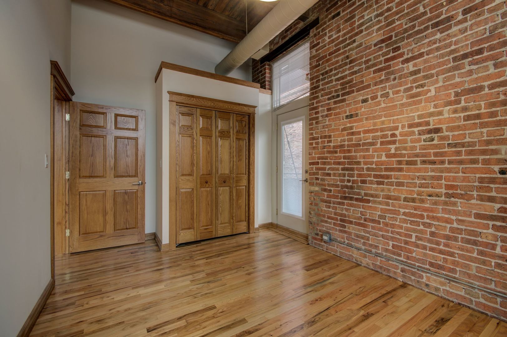 216 North May Street, Unit 303 Chicago, IL 60607 - Photo 13 of 19 a view of a brick house with wooden floor