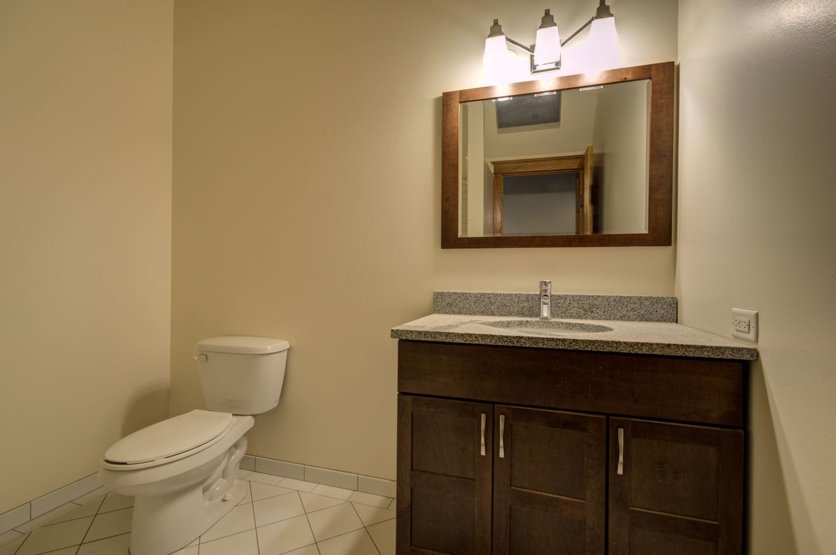216 North May Street, Unit 303 Chicago, IL 60607 - Photo 18 of 19 a bathroom with a toilet a sink and mirror