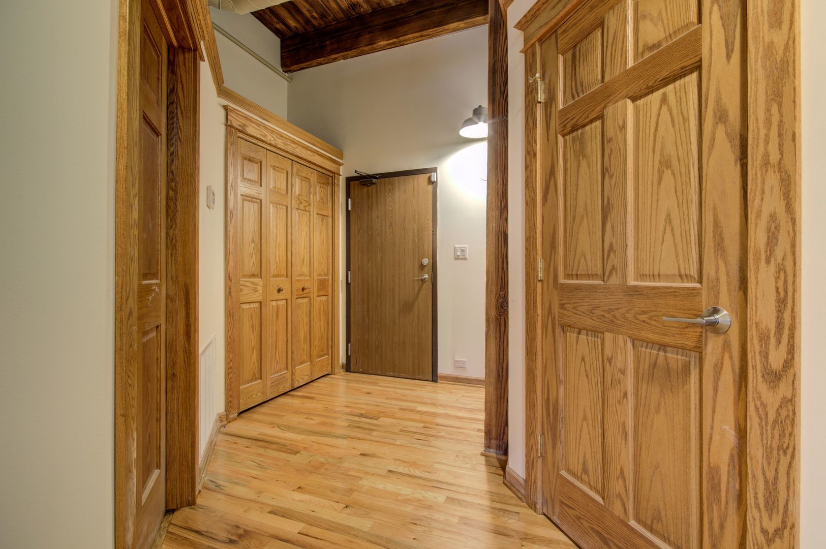 216 North May Street, Unit 303 Chicago, IL 60607 - Photo 3 of 19 a view of a hallway with wooden floor and entryway
