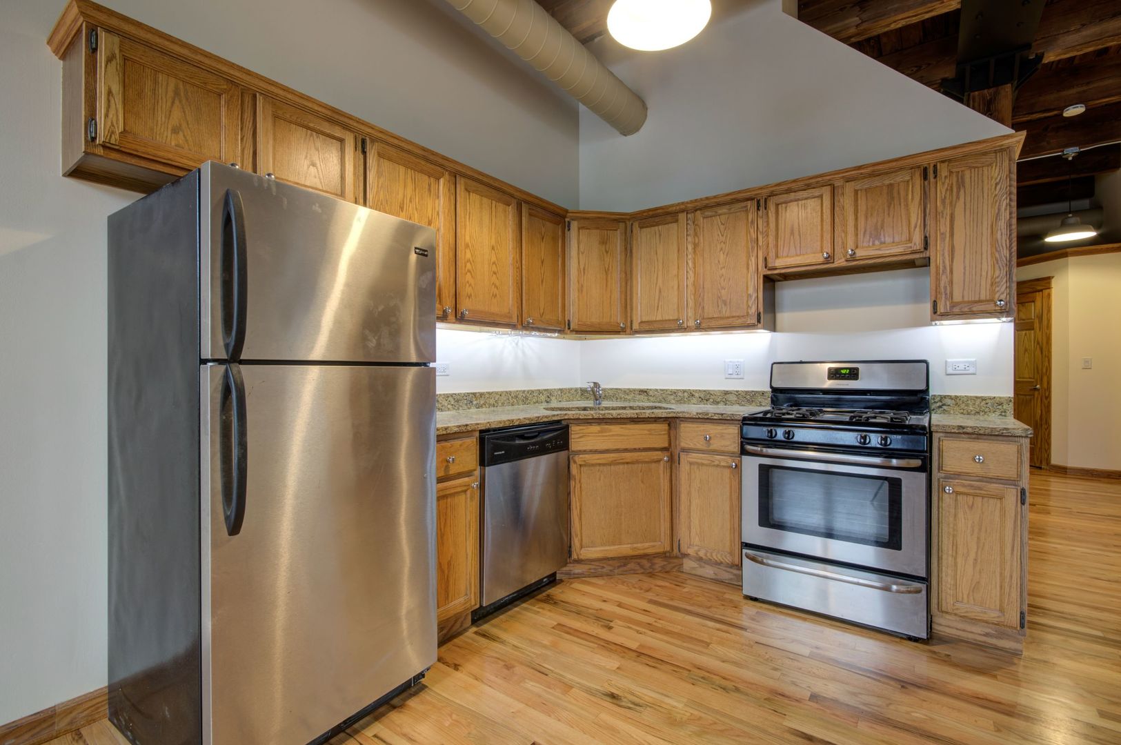 216 North May Street, Unit 303 Chicago, IL 60607 - Photo 6 of 19 a kitchen with a refrigerator sink and stove