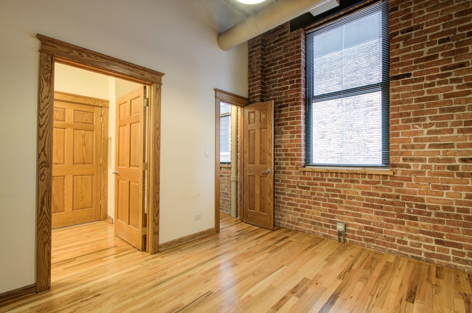 216 North May Street, Unit 303 Chicago, IL 60607 - Photo 10 of 19 a view of a livingroom with wooden floor and a window