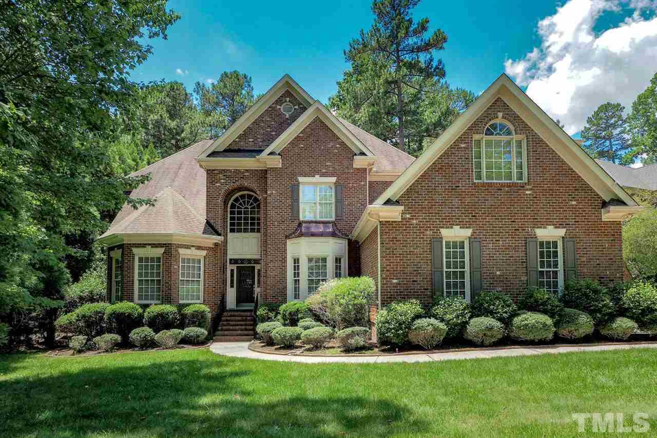 7017 Potomac Court Raleigh, NC 27613 - Photo 1 of 25 a front view of a house with a yard and potted plants
