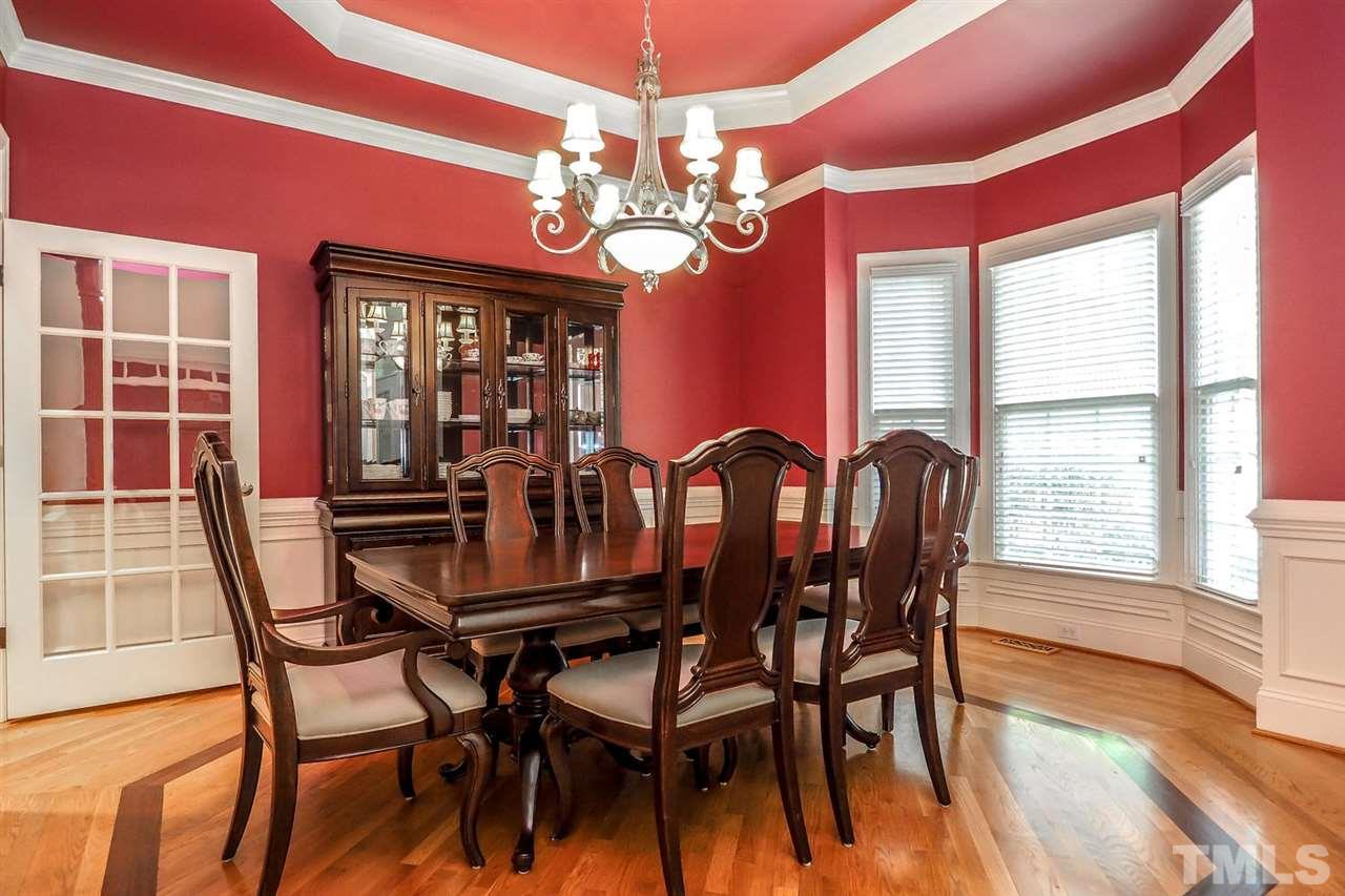 7017 Potomac Court Raleigh, NC 27613 - Photo 2 of 25 a view of a dining room with furniture a chandelier and wooden floor