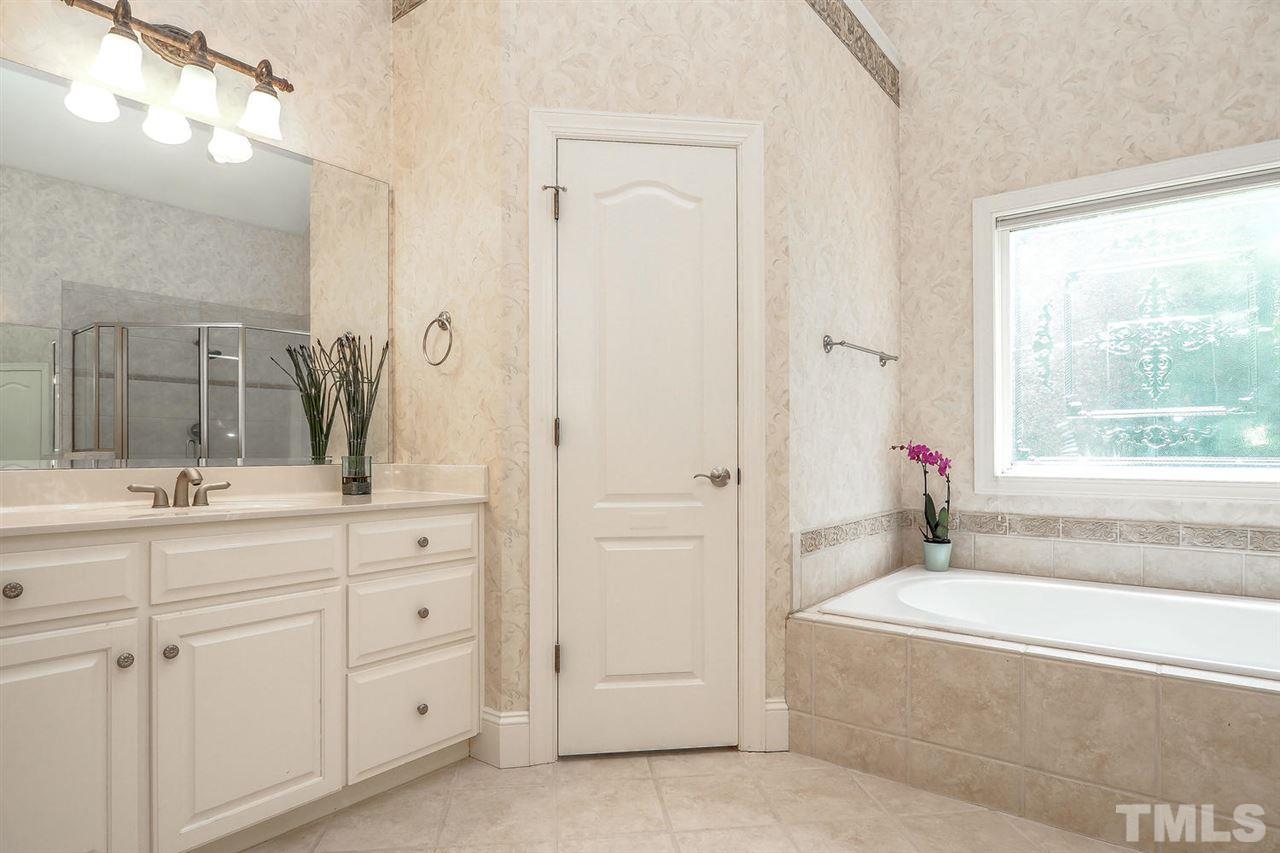 7017 Potomac Court Raleigh, NC 27613 - Photo 14 of 25 a bathroom with a bathtub and a sink