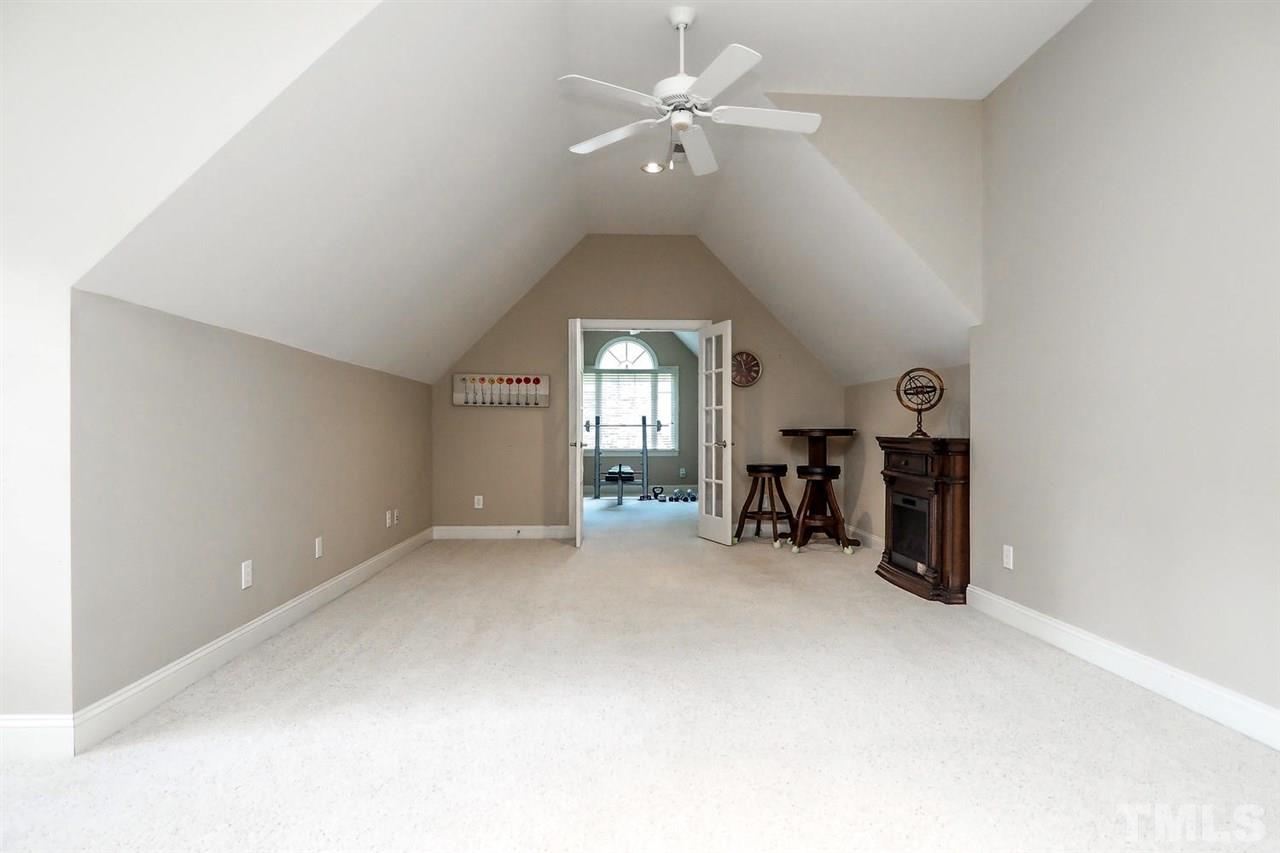 7017 Potomac Court Raleigh, NC 27613 - Photo 17 of 25 an empty room with closet and a chandelier fan