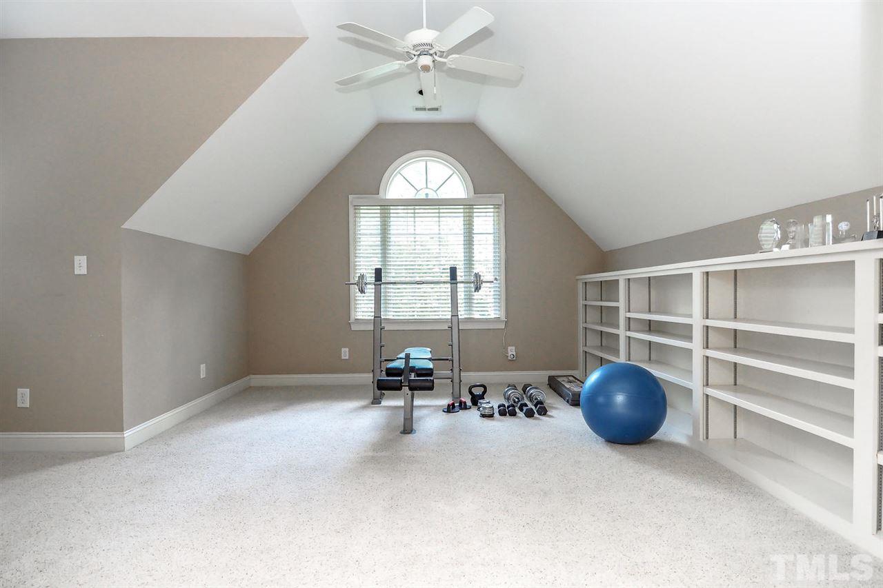 7017 Potomac Court Raleigh, NC 27613 - Photo 18 of 25 an empty room with chandelier fan and windows