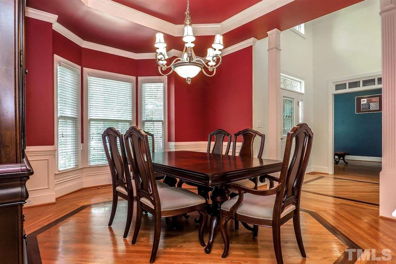 7017 Potomac Court Raleigh, NC 27613 - Photo 3 of 25 a dining room with furniture a chandelier and wooden floor