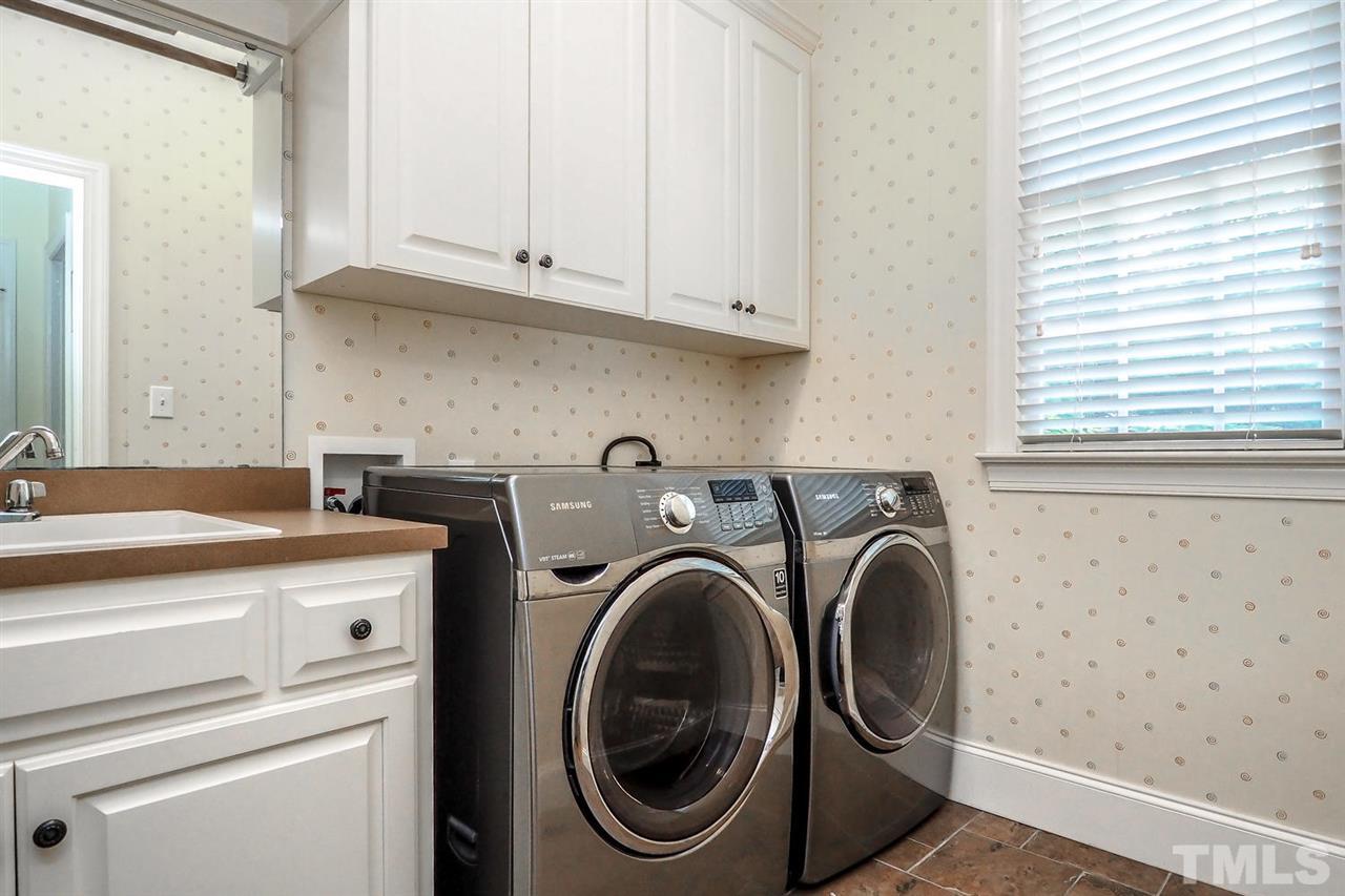 7017 Potomac Court Raleigh, NC 27613 - Photo 23 of 25 a utility room with dryer and washer