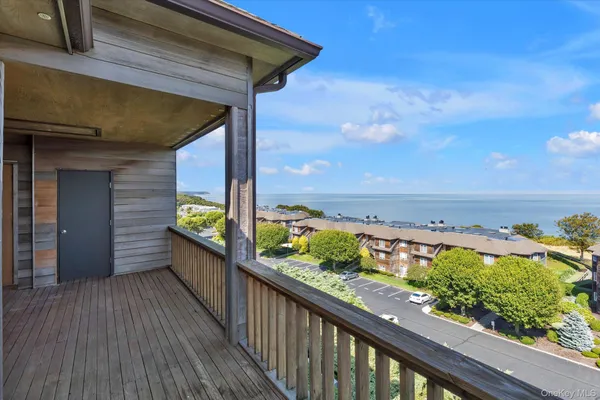 a view of a balcony with wooden floor