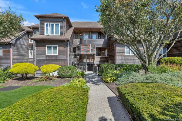 a view of a house with a garden and pathway