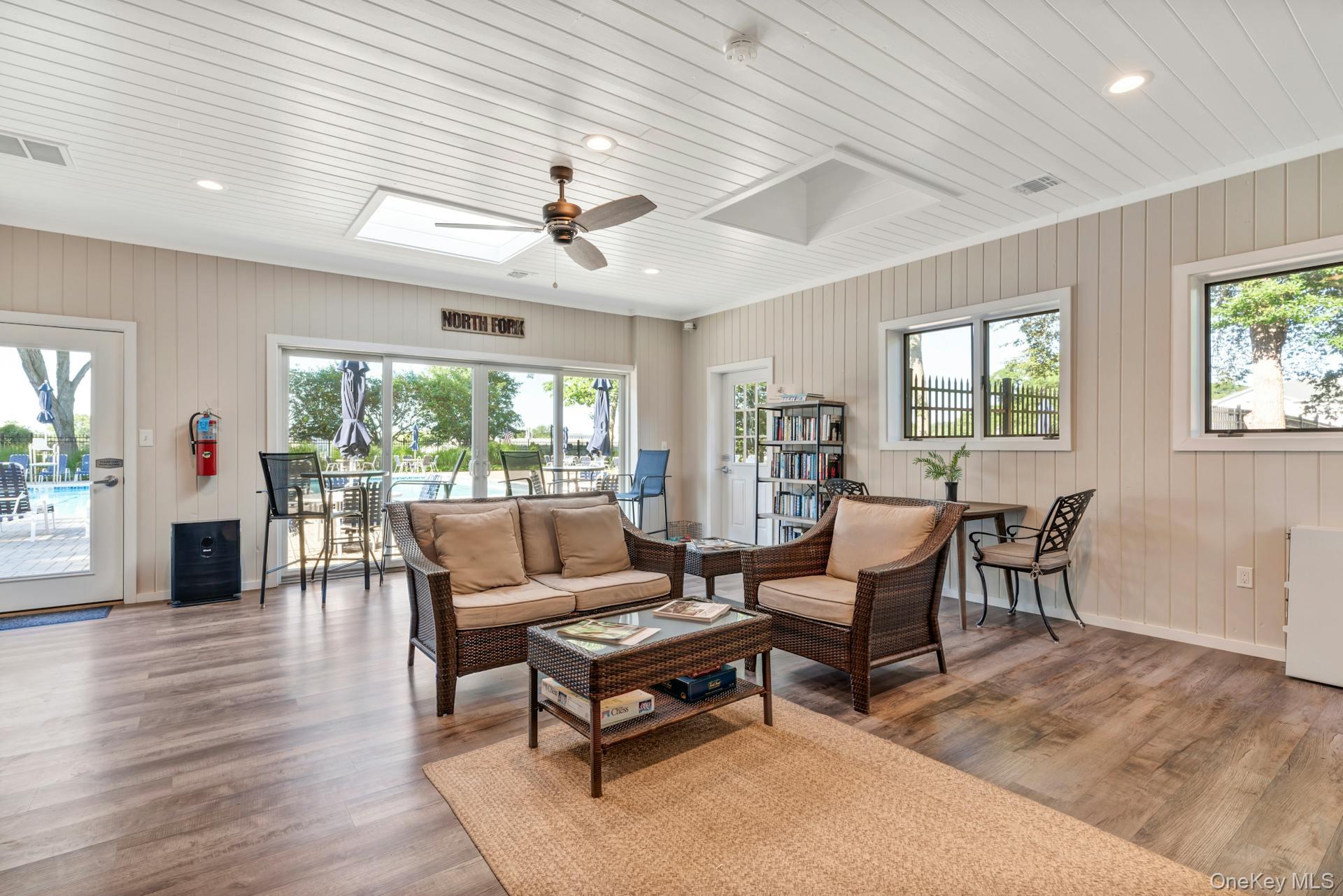 209 Fox Hill Drive Baiting Hollow, NY 11933 - Photo 24 of 28 Living room featuring healthy amount of natural light, recessed lighting, ceiling fan, wood finished floors, and wood ceiling