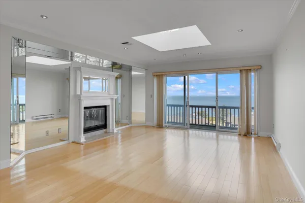 an empty room with wooden floor and fireplace