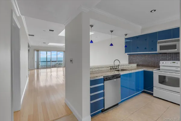 a kitchen with stainless steel appliances granite countertop a sink and wooden cabinets