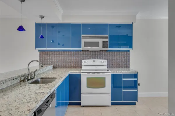 a kitchen with sink a stove and cabinets