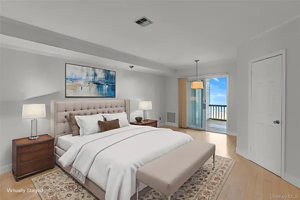 a bedroom with a large bed and a night stand