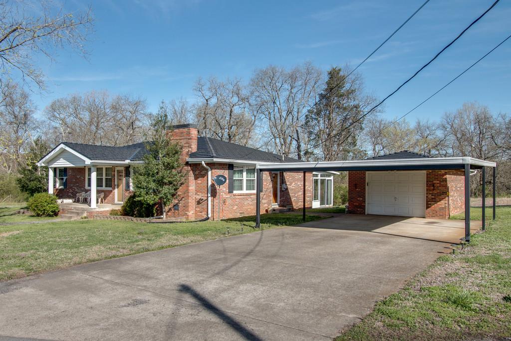 1585 Taylorsville Road Lebanon, TN 37087 - Photo 3 of 28 Brick garage/workshop w/walk thru door and two car metal carport
