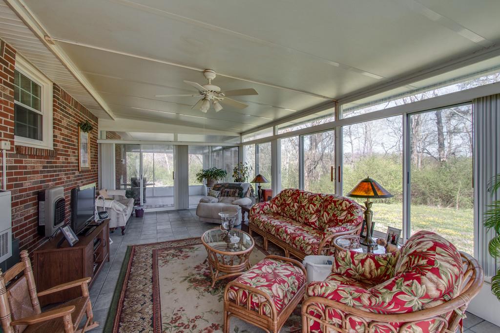 1585 Taylorsville Road Lebanon, TN 37087 - Photo 21 of 28 This 30X14 Florida Room is heated and cooled with custom windows and door(handicap accessible) opening to outside and screened in porch