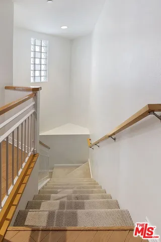 a view of staircase with white walls and windows