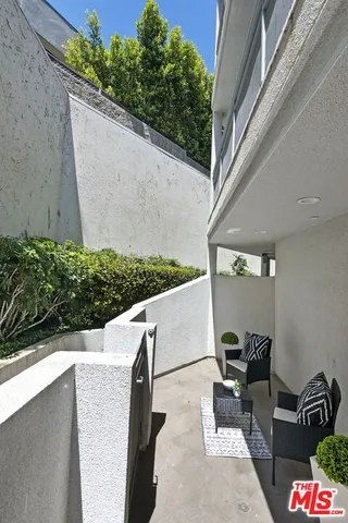 a dining room with furniture and a floor to ceiling window