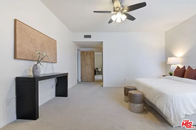 a spacious bathroom with a double vanity sink mirror and toilet